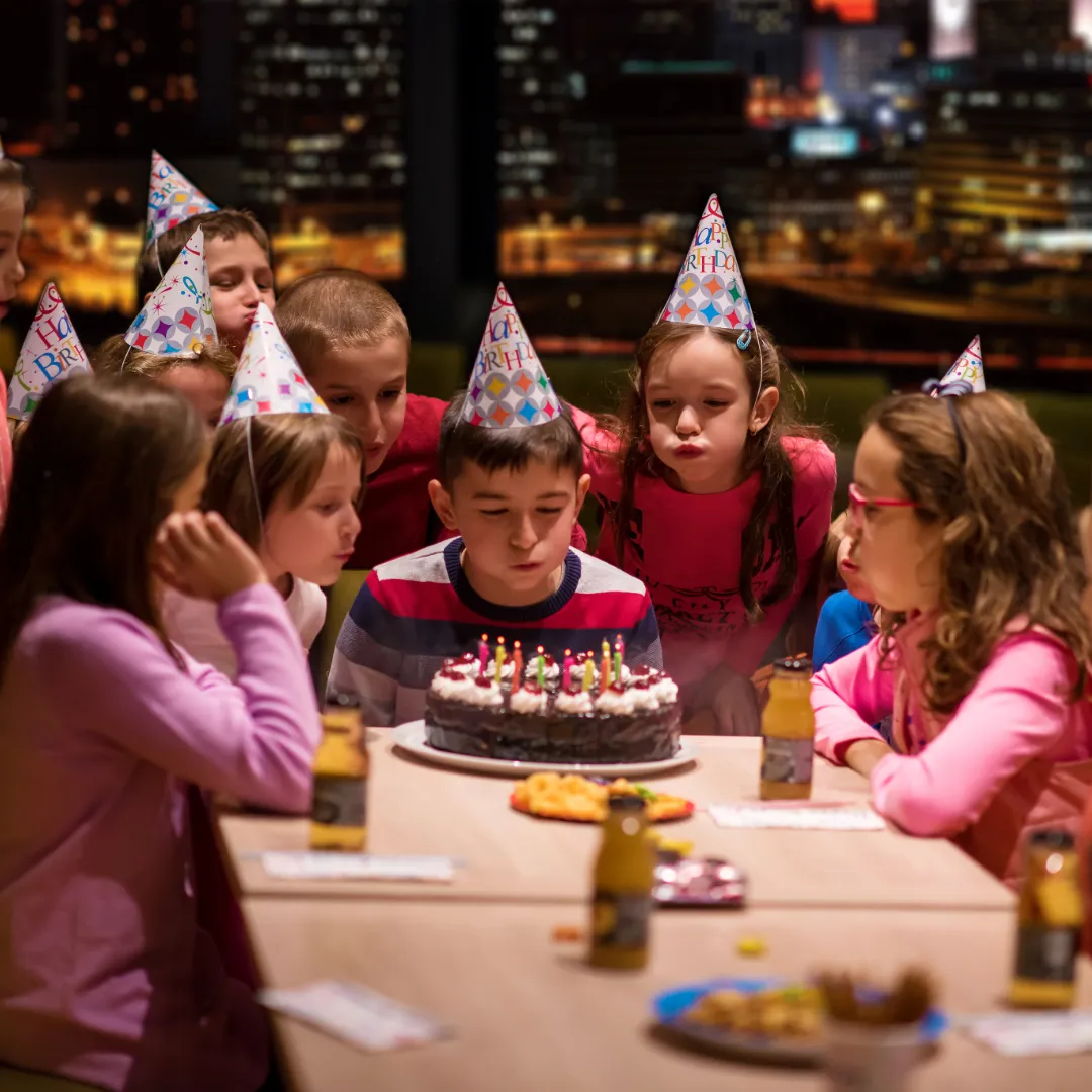 Boy blowing out candles at a private kids birthday party near LAX